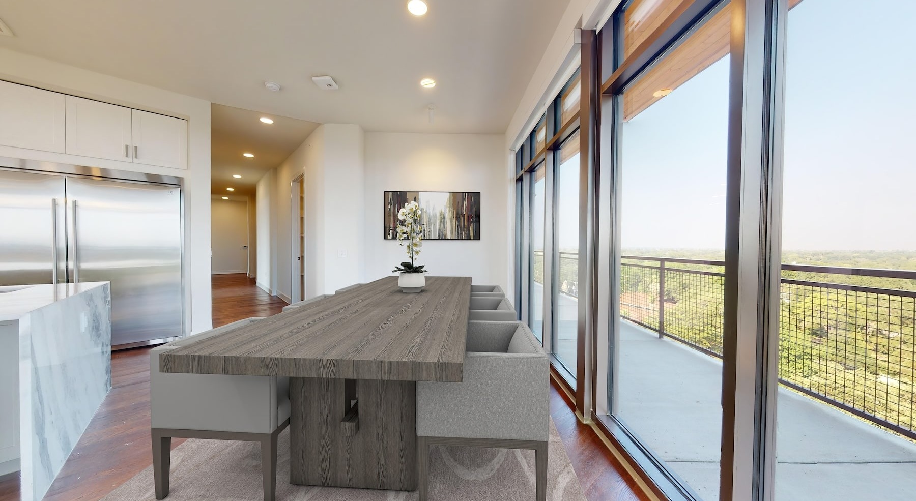 a table and dining area beside a large window